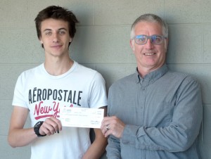 A man presenting a cheque to a student
